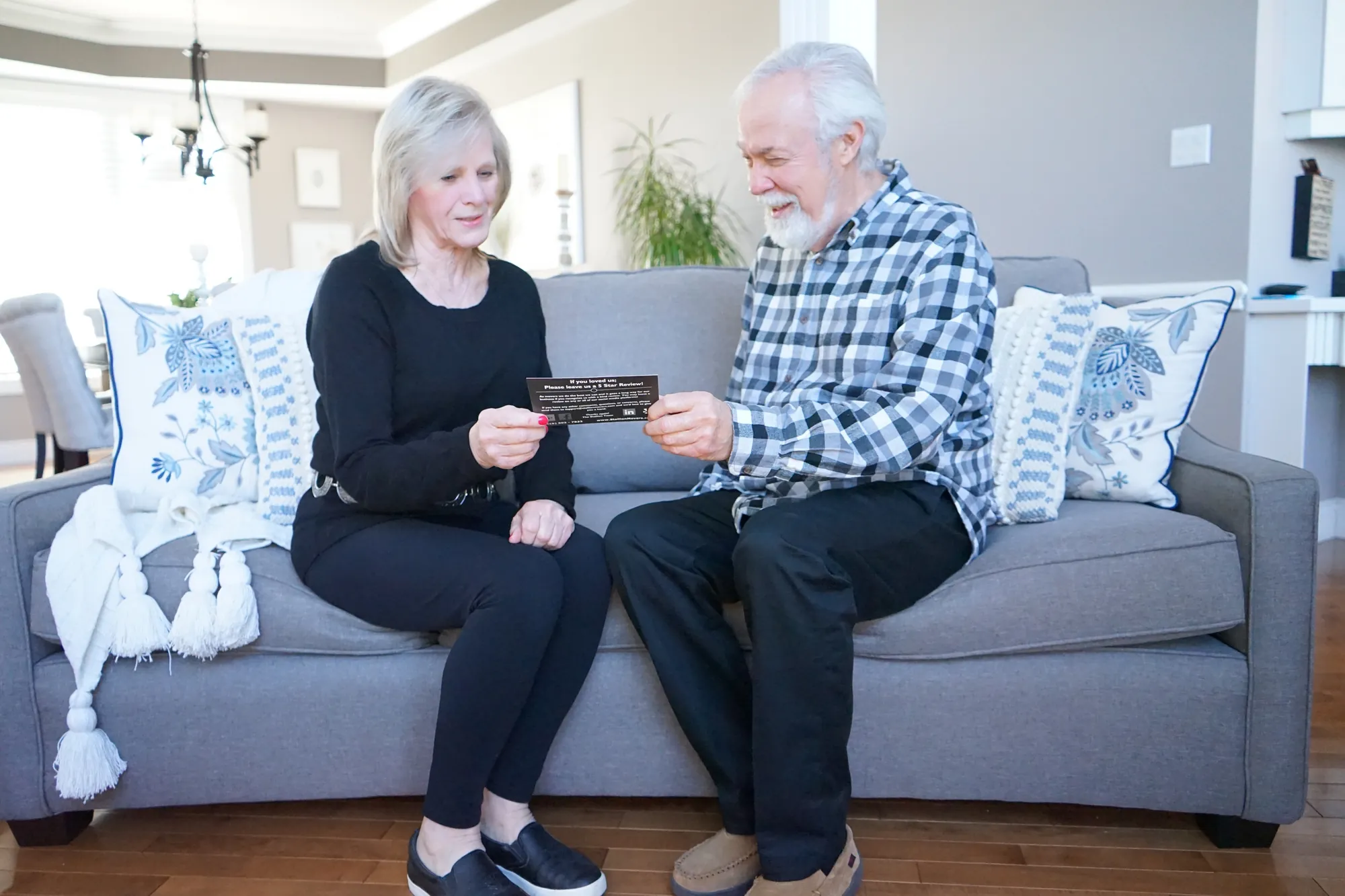 A smiling couple, Stallion Movers clients, at home