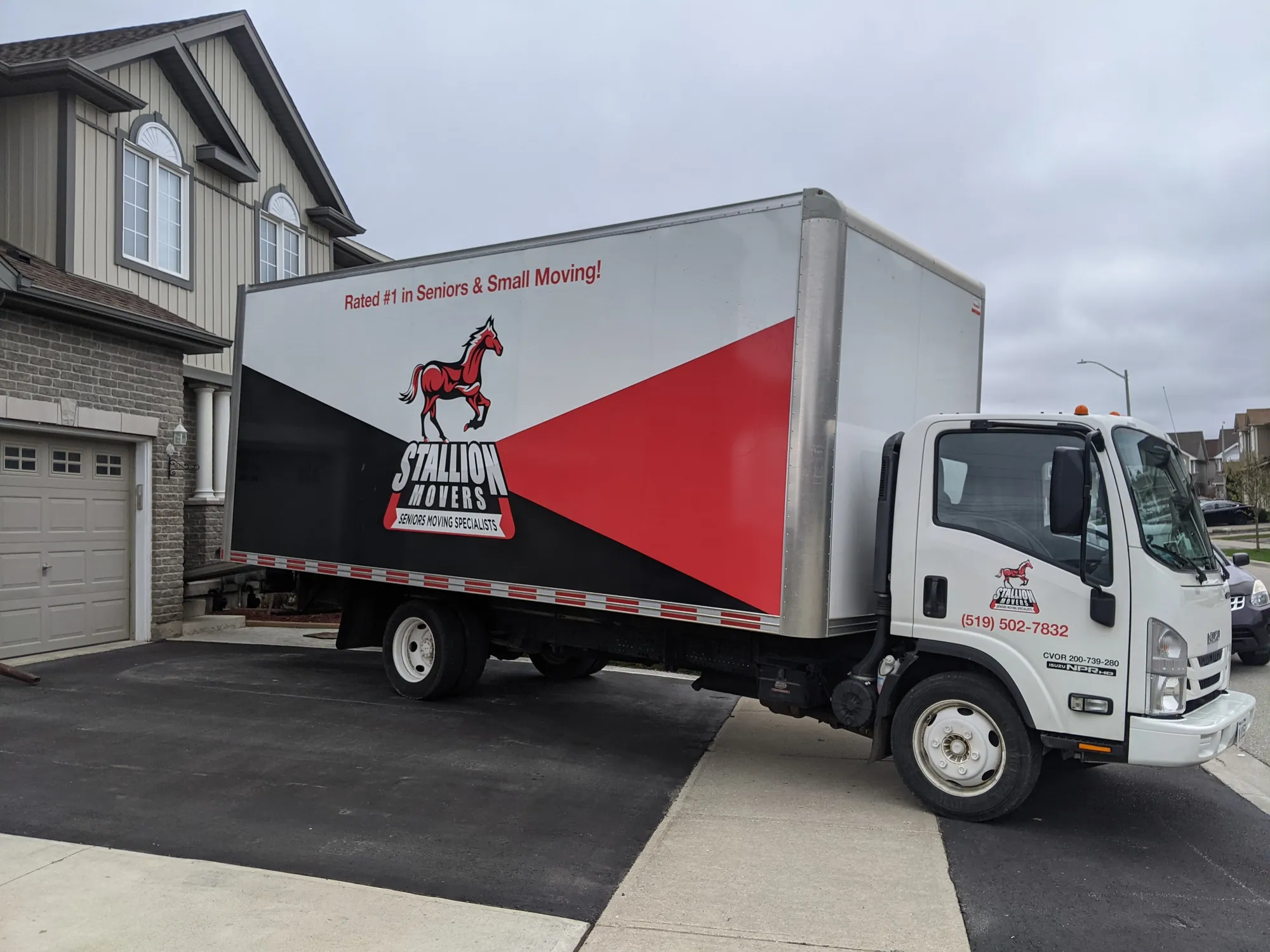 A Stallion moving truck parked in a residential driveway